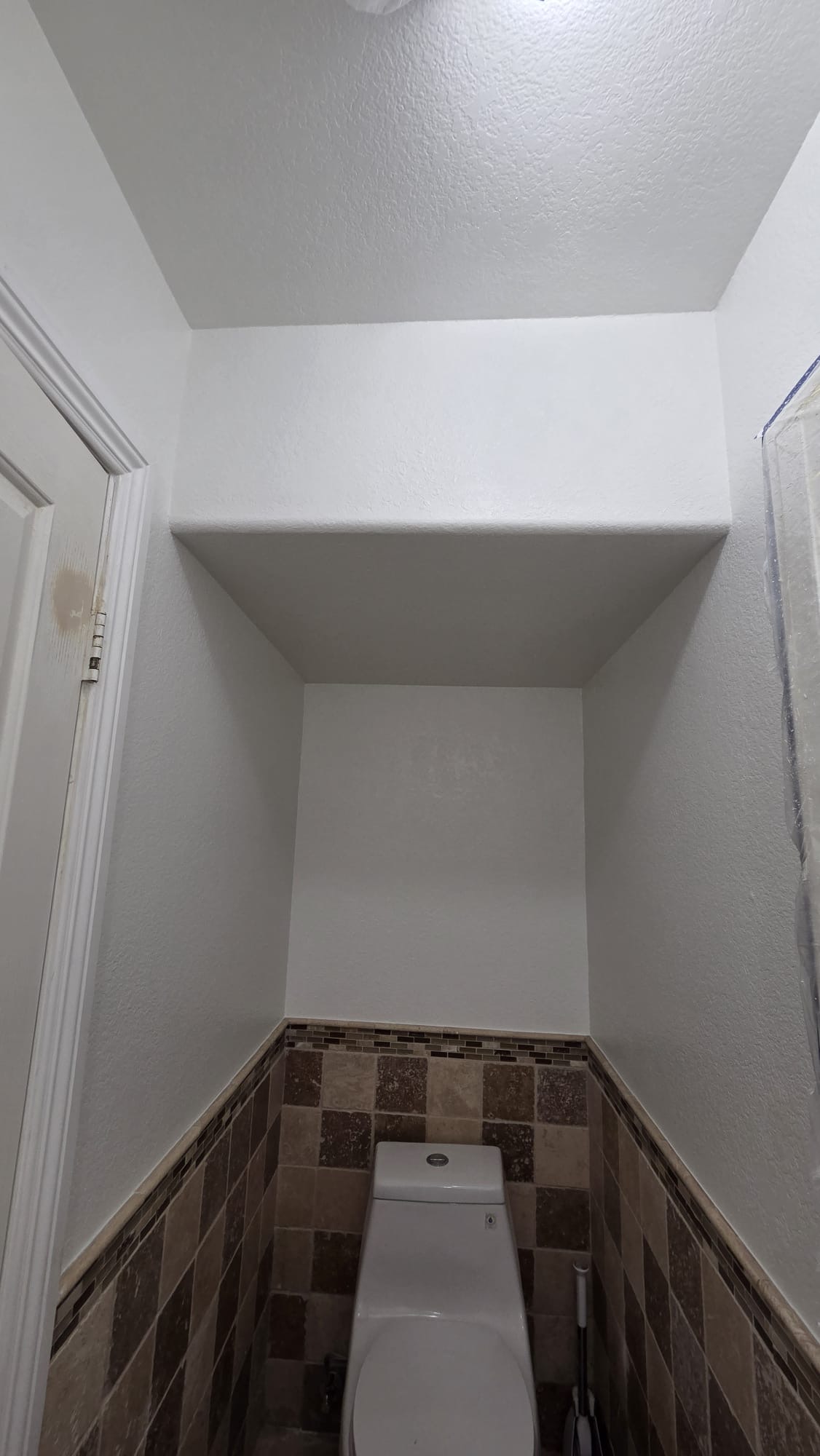 Same bathroom toilet wall after drywall repair, Snowdown texture and painting