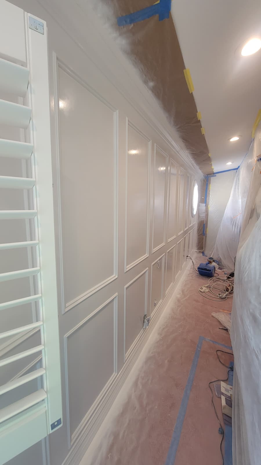 Decorative wall paneling after painting, with a smooth uniform white finish