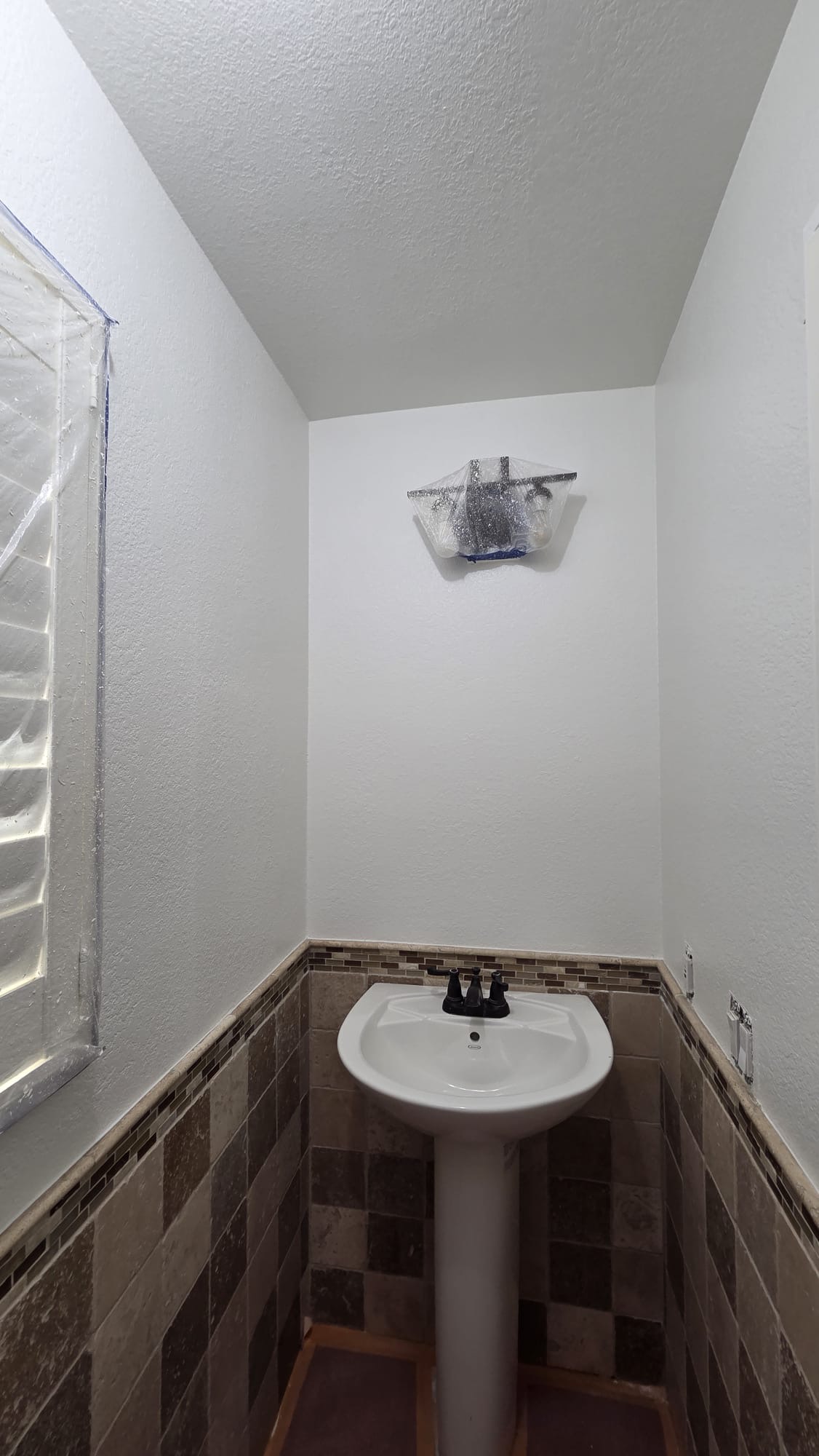 Same bathroom sink wall after drywall repair, Snowdown texture and painting